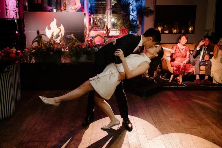A bride and groom mid-dip on the dance floor, first dance, Elizabeth Hsieh Make Up Artist