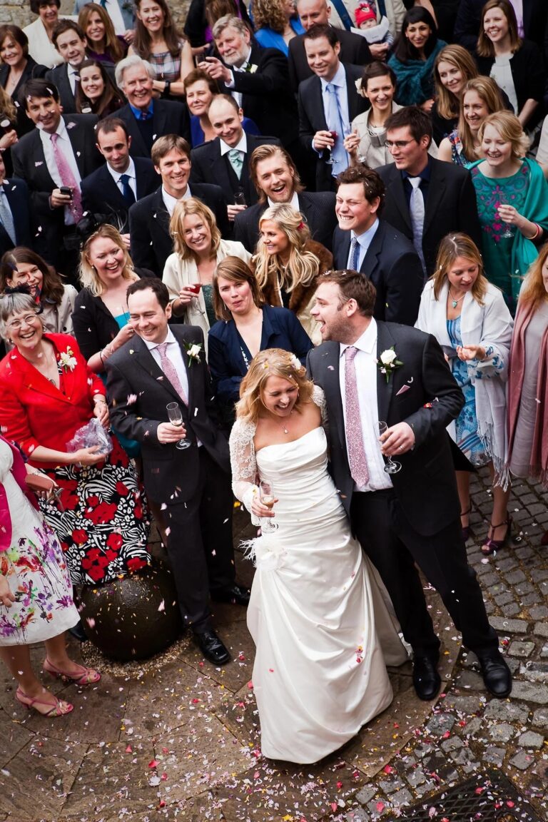 A bride and groom walking through confetti and a crowd of guests, Notley Abbey, Elizabeth Hsieh Make Up Artist