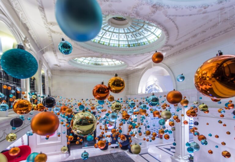 A hanging installation of coloured baubles in a domed room, Elizabeth Marsh Floral Design