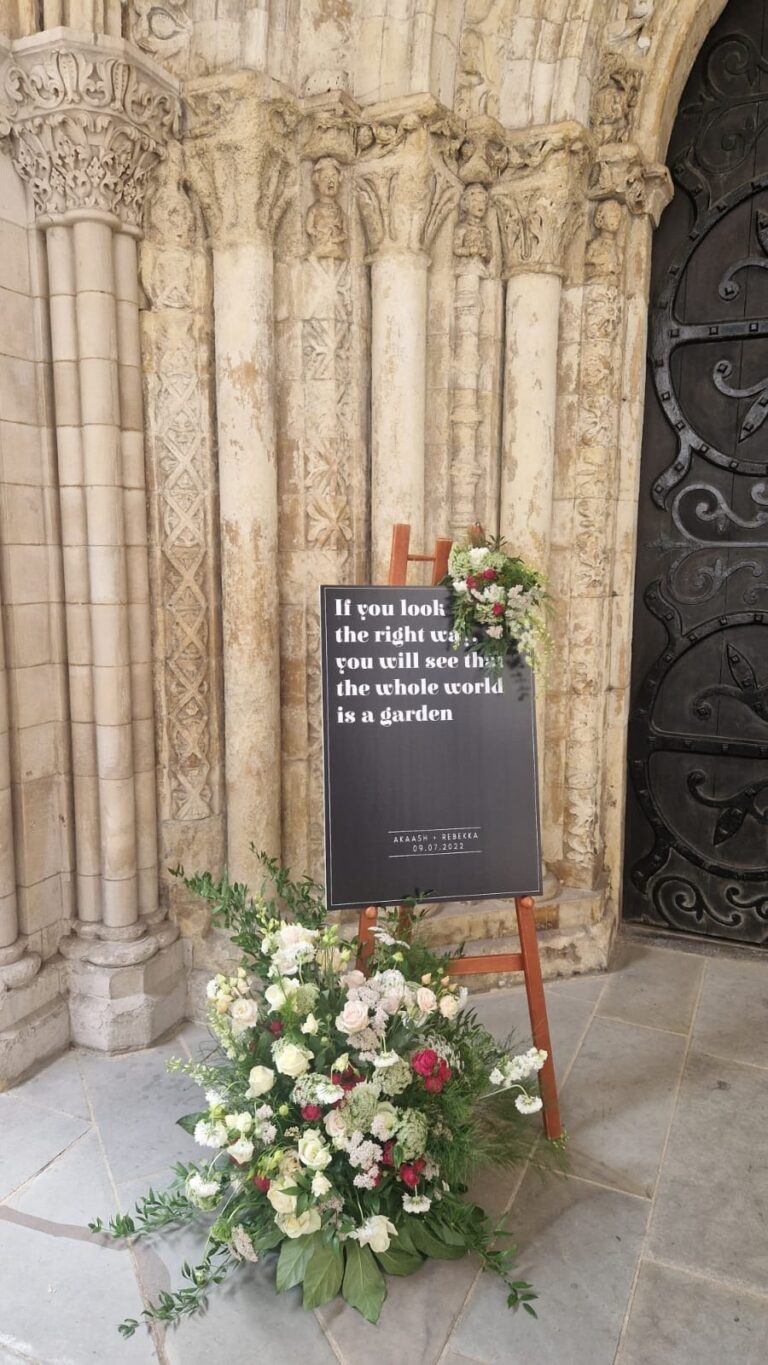 A welcome sign and floral base at the church door, Elizabeth Marsh Floral Design