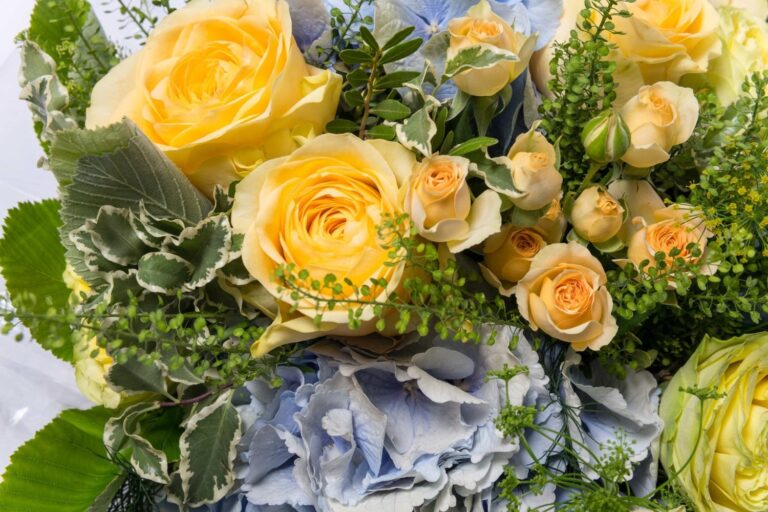 A bouquet of yellow roses and blue hydrangea, close up, Elizabeth Marsh Floral Design