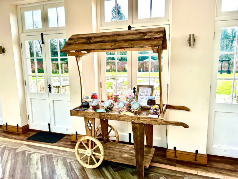The wooden sweet trolley, one of the complimentary extras, inside the Orangery by its garden doors, Elmhay Park