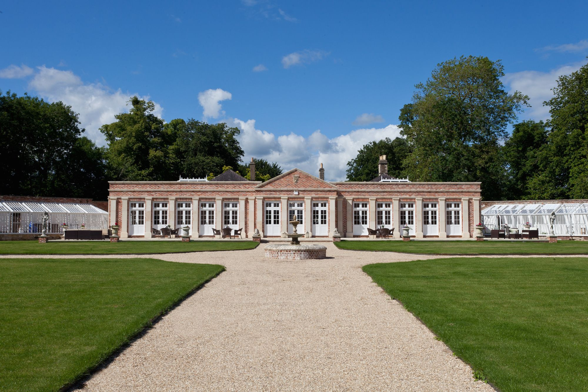The Orangery at the head of the Walled Garden, with a gravel path between lawns leading to the fountain, Elmhay Park