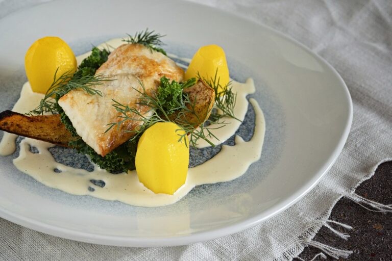 A plated fish course with lemon, Elmore Court