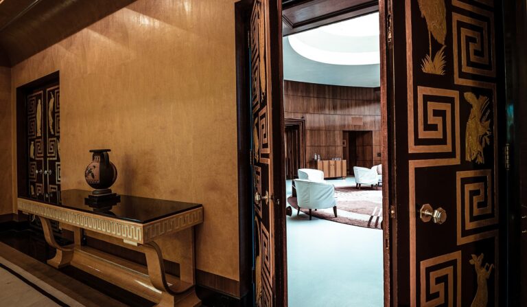 The lacquered Greek-key doors of the Entrance Hall open onto the domed room beyond, Eltham Palace