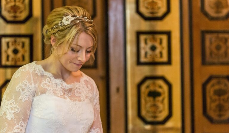 A bride before the lacquered marquetry doors of the Art Deco Entrance Hall, Eltham Palace