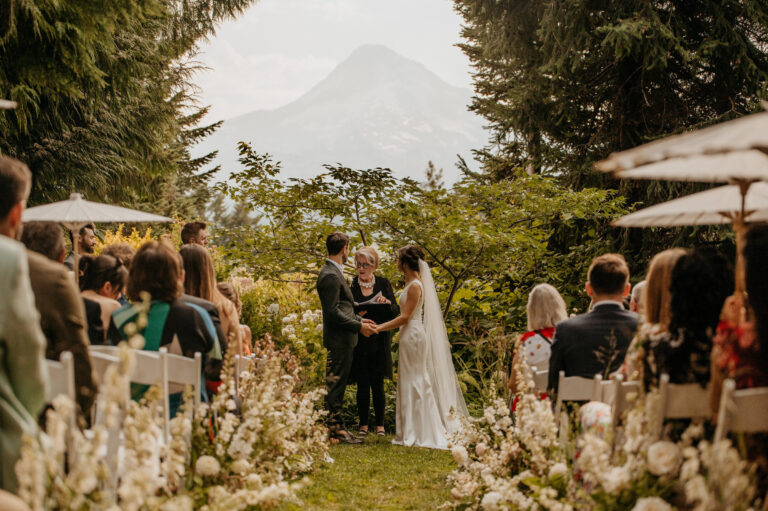 Outdoor ceremony among pampas grass arrangements with a mountain behind, Emett Joseph Photography