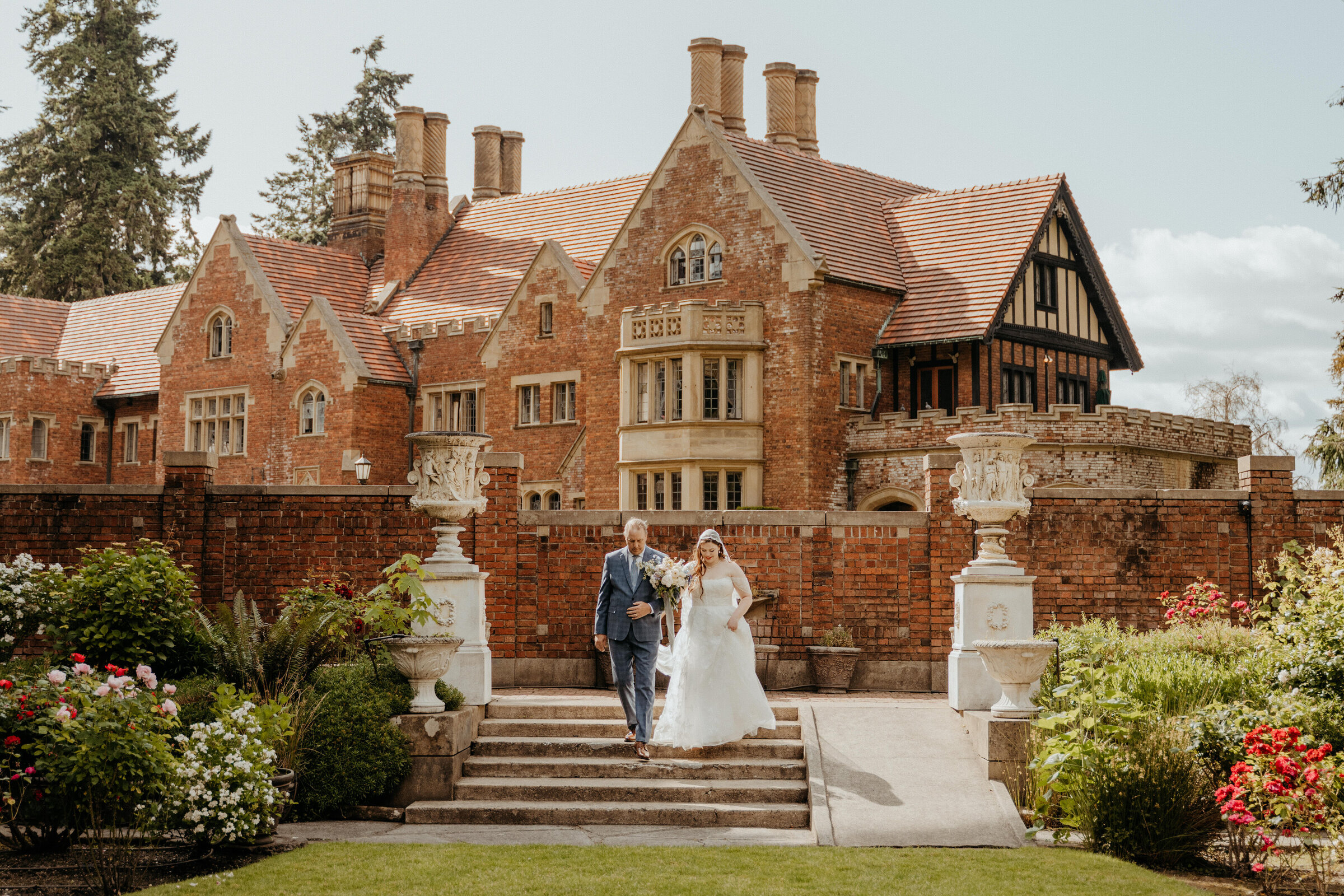 Couple on the steps of a brick manor house garden at Thornewood Castle, Washington, Emett Joseph Photography