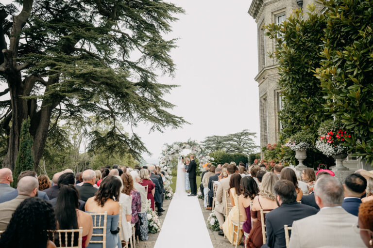 Guests seated along the aisle for an outdoor ceremony beside Hedsor House in Buckinghamshire, Emma-Jane Photography