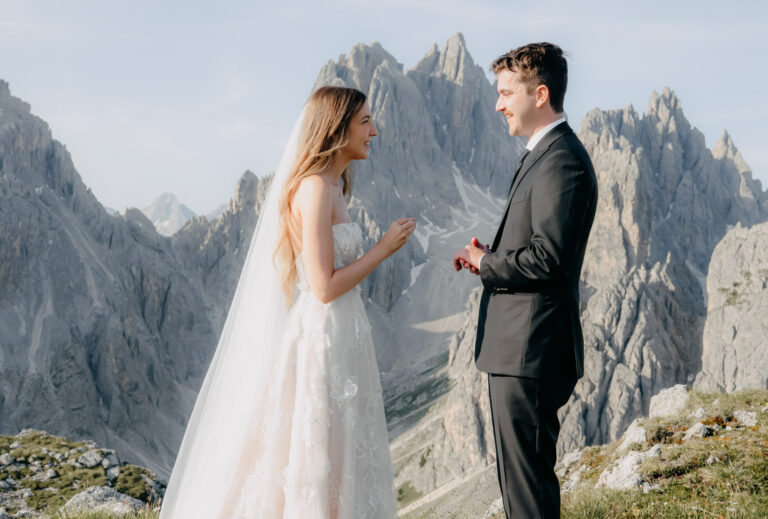 Personal vows read on a Dolomites ridge, with jagged peaks behind, Emma-Jane Photography