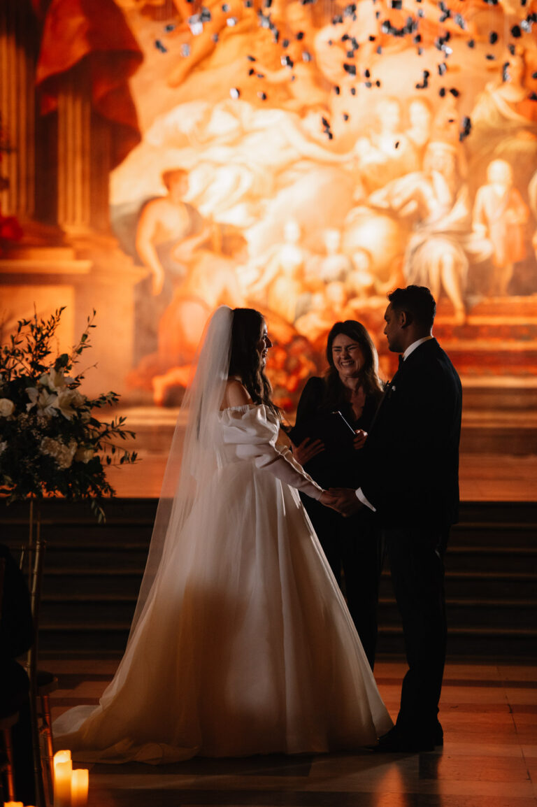 The couple at the front of the Painted Hall in Greenwich during their ceremony, Emma-Jane Photography
