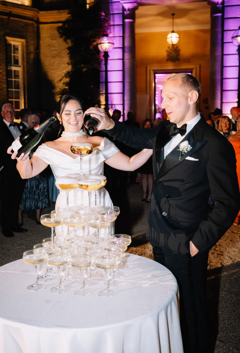 The couple pouring a champagne tower at Hedsor House, Emma-Jane Photography