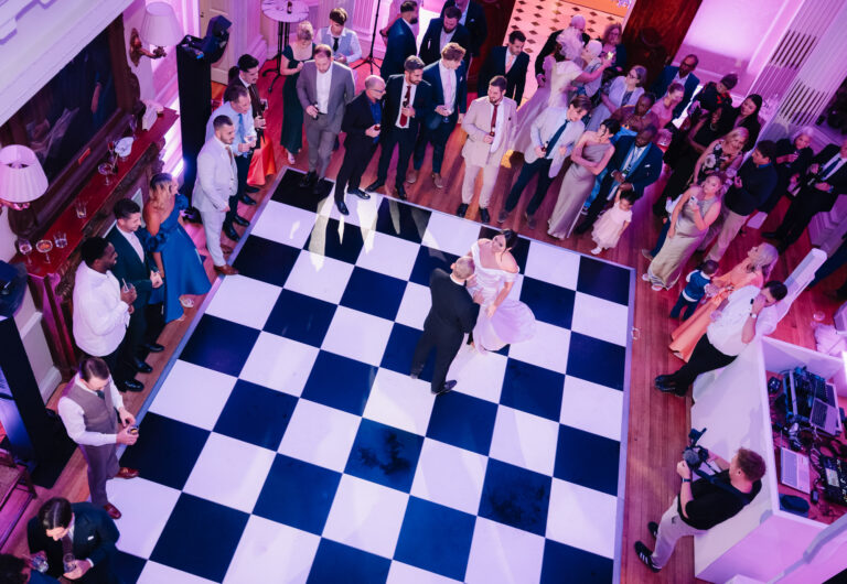 The couple on a chequered dance floor at Hedsor House, seen from above, guests gathered round, Emma-Jane Photography