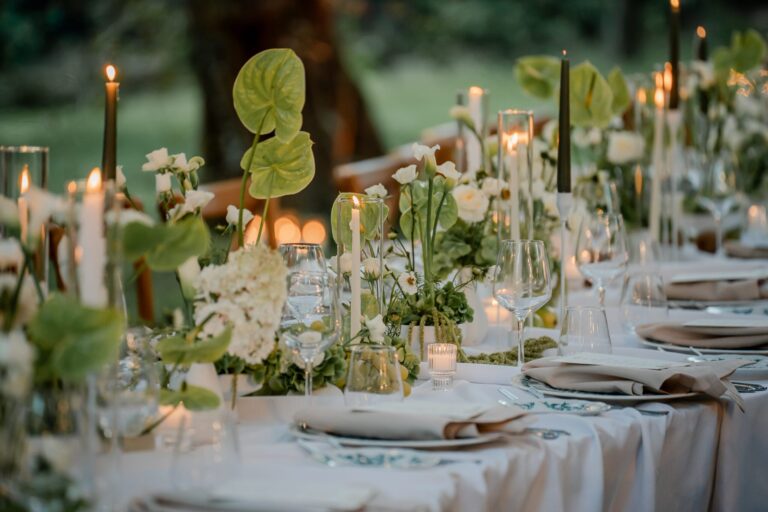 Green anthuriums and tapers down a table laid under the trees, Ester Chianelli Weddings & Events