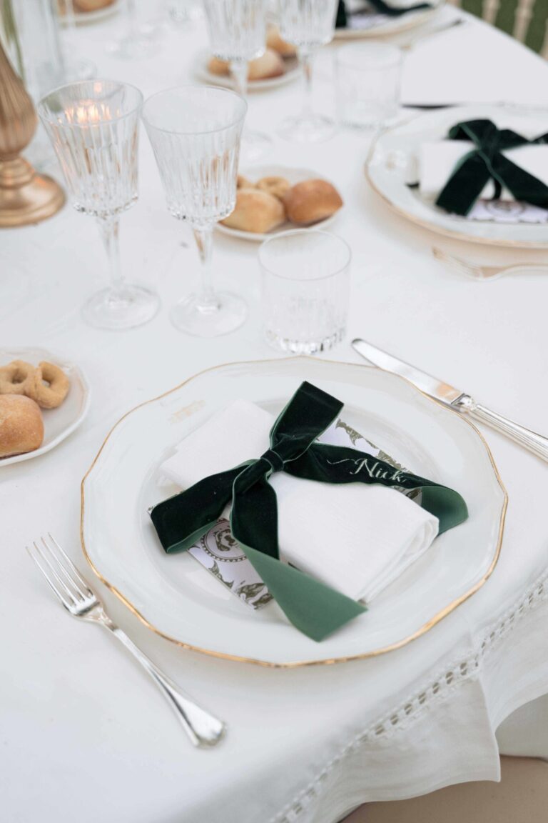 A gilt-edged plate, a dark green velvet bow, taralli, Ester Chianelli Weddings & Events