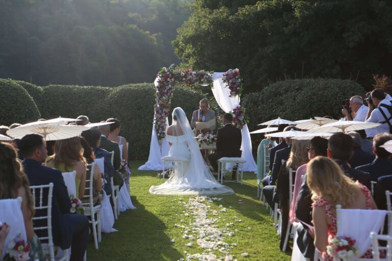 Garden ceremony at the Antiche Scuderie Odescalchi, guests seated before a floral arch, Eventilab Weddings