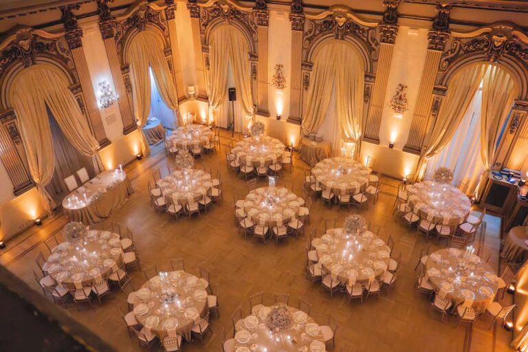 The gala ballroom at Palazzo Brancaccio in Rome from above, round tables lit in warm gold, Eventilab Weddings