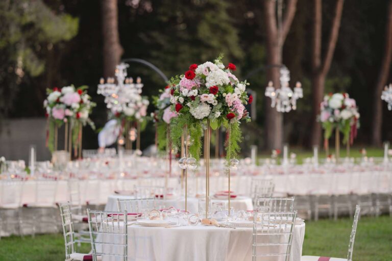 Garden tables at Villa Dino on the Appia Antica, tall red and white arrangements with crystal chandeliers, Eventilab Weddings