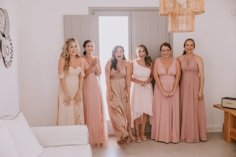Bridesmaids in soft pink and cream dresses gathered in a white room before the ceremony, Eventuries Wedding Planning and Styling