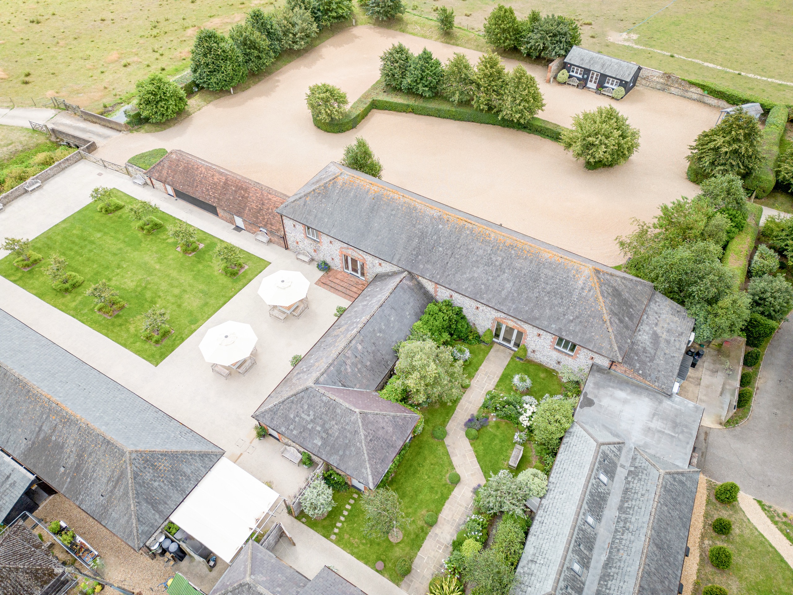 Looking down on the courtyard lawn, the guest room range and the planted gardens between the barns, Farbridge