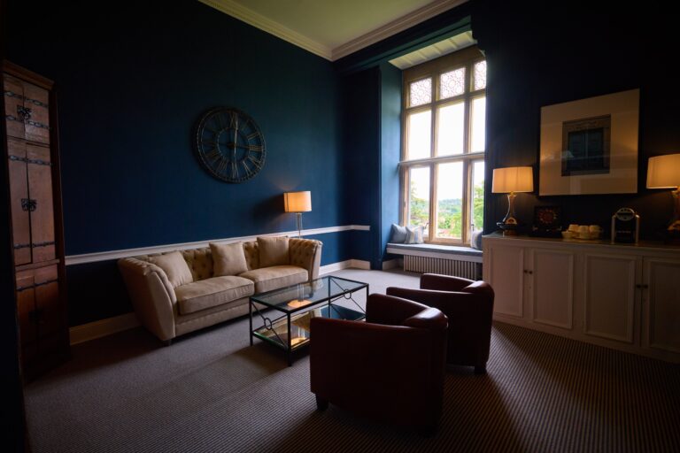 The Pembroke, a dark-panelled sitting room used by the wedding party to get ready, with a window over the grounds, Farnham Castle