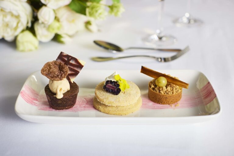 A dessert trio of chocolate, sablé and tart on a long plate, Farnham Castle