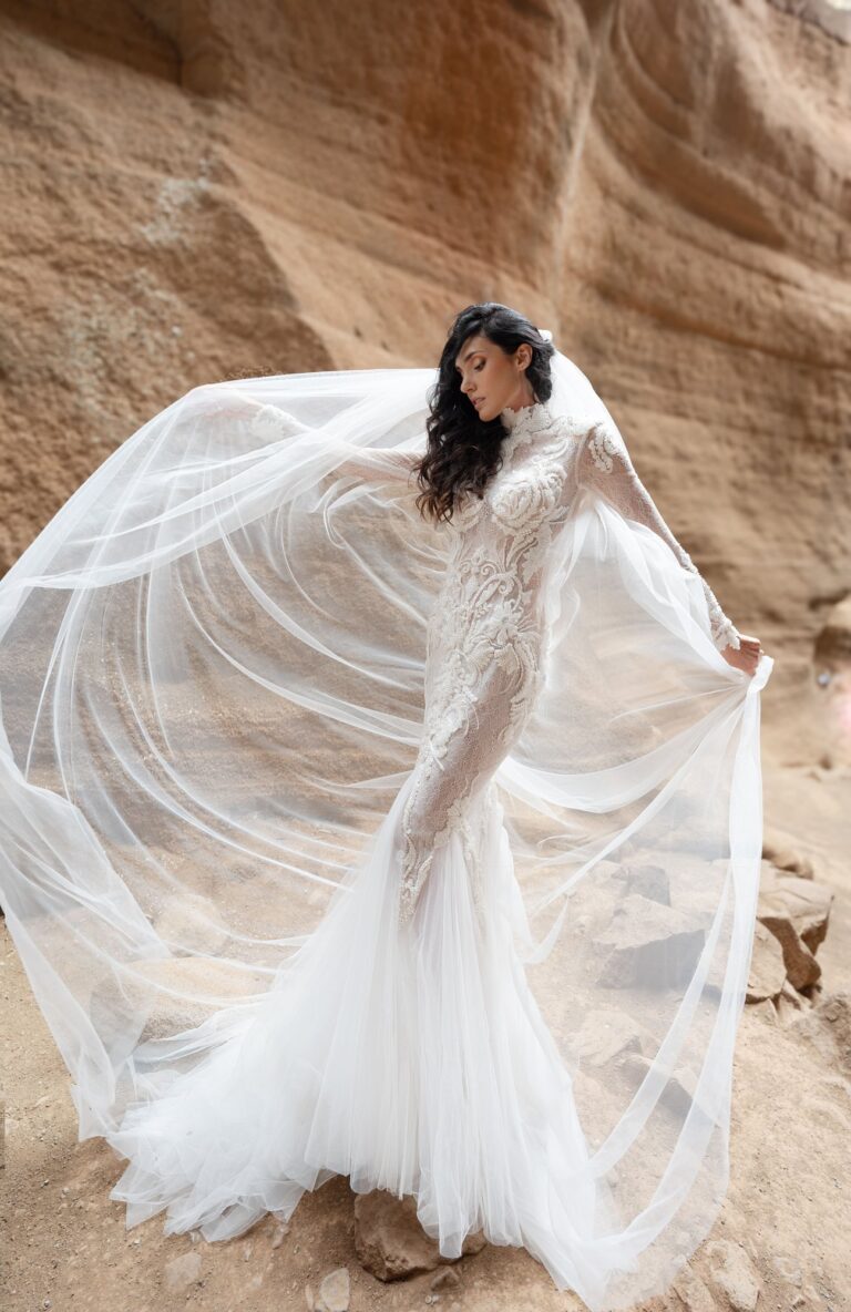 Ferdinand Atelier couture: a veil lifted by the wind over a lace gown