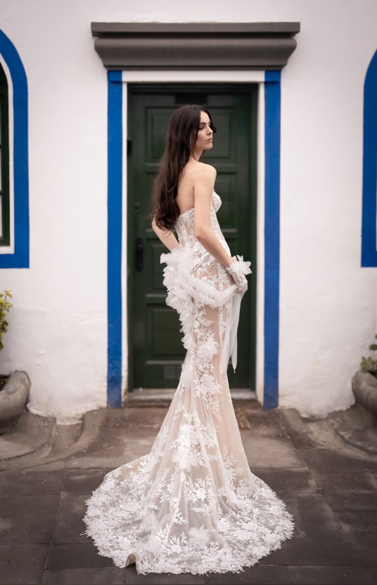 Ferdinand Atelier couture: a lace gown at a blue and white doorway
