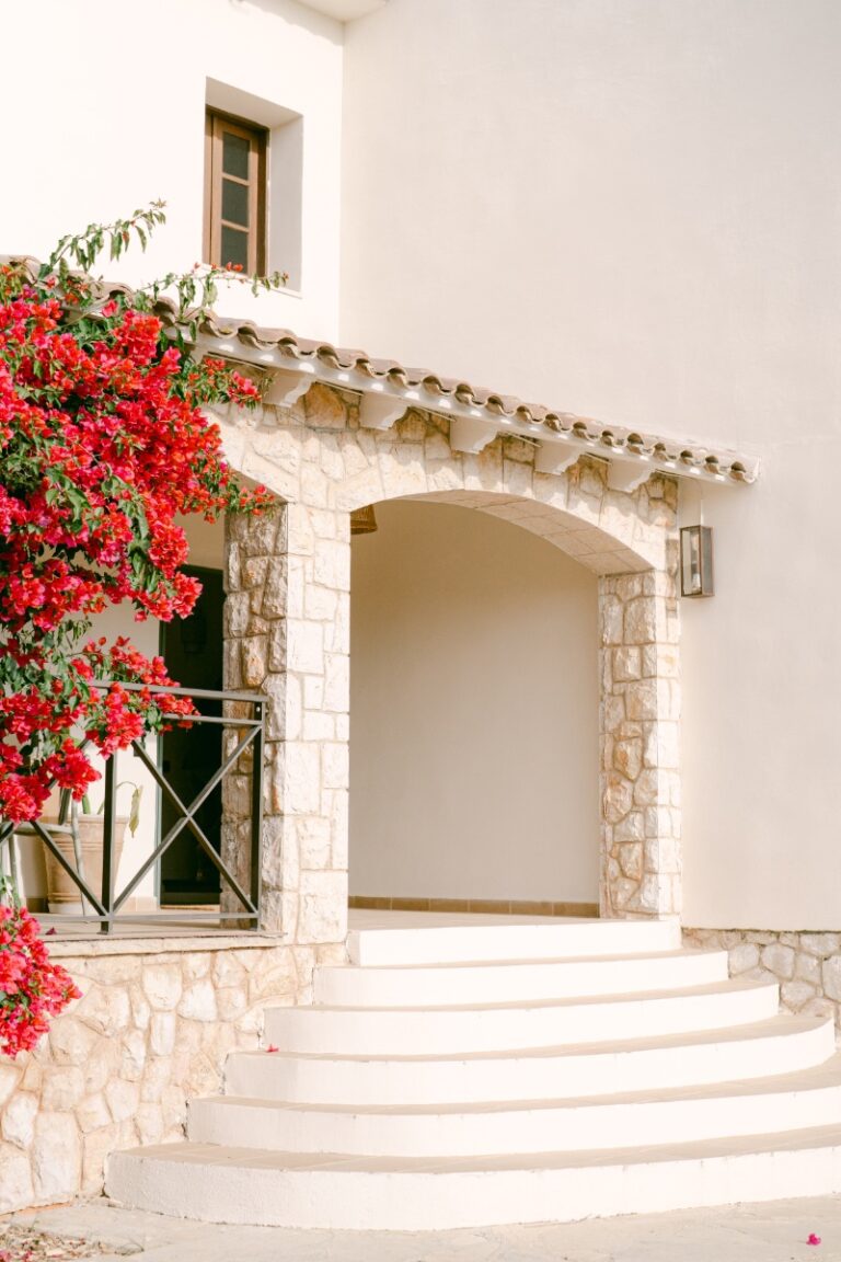 Stone arch entrance framed by bougainvillea, Finca La Concertista