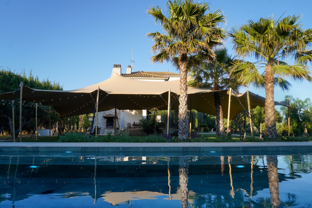 Pool terrace with stretch tent and palm trees, Finca La Concertista