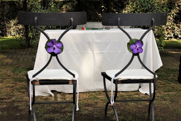 Two wrought-iron chairs each marked with a purple flower for the signing table, Fiori Amore Fantasia