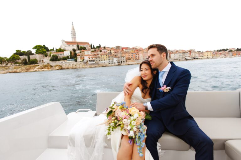 A couple on a boat with the Rovinj skyline and bell tower behind, Flammeum