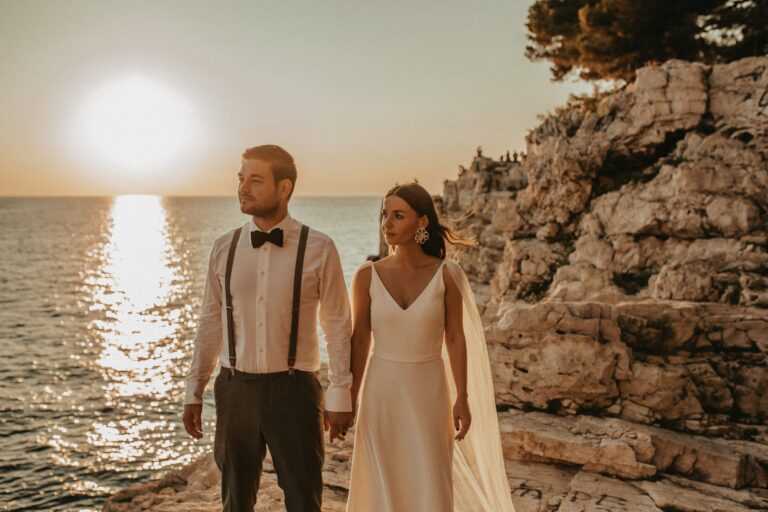 A couple at sunset on a rocky shoreline, Istria, Flammeum