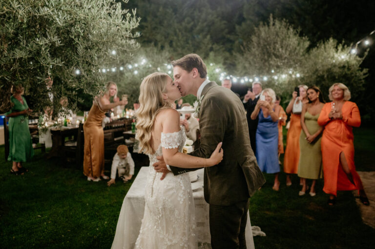 A kiss at an evening reception under festoon lights in an olive grove, Istria, Flammeum