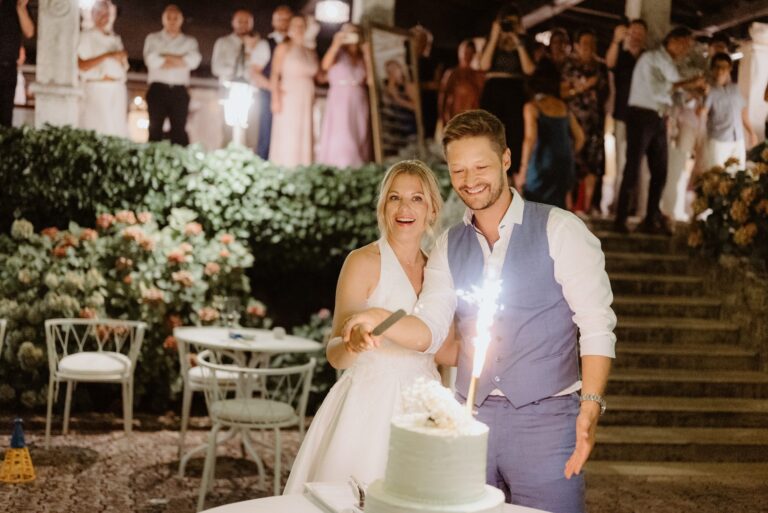 The couple cut the cake with a sparkler on a stone terrace at night, Istria, Flammeum
