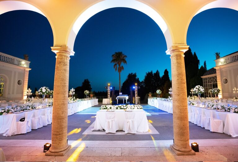 Villa Miani's colonnade at night, a sweetheart table beneath the arches, Flavia Bruni