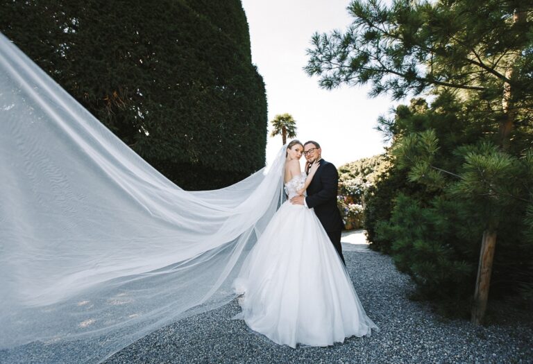 A bride's cathedral veil catches the wind in the gardens above Lake Maggiore, Flavia Bruni