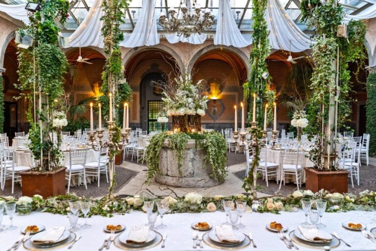 The reception courtyard, an ancient stone well dressed in ivy and candlelight, Flavia Bruni
