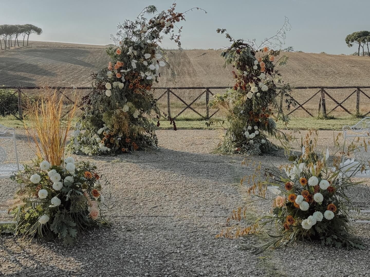 Twin autumn floral arches of dried grasses and burgundy blooms, I Casali del Pino, Floreventi