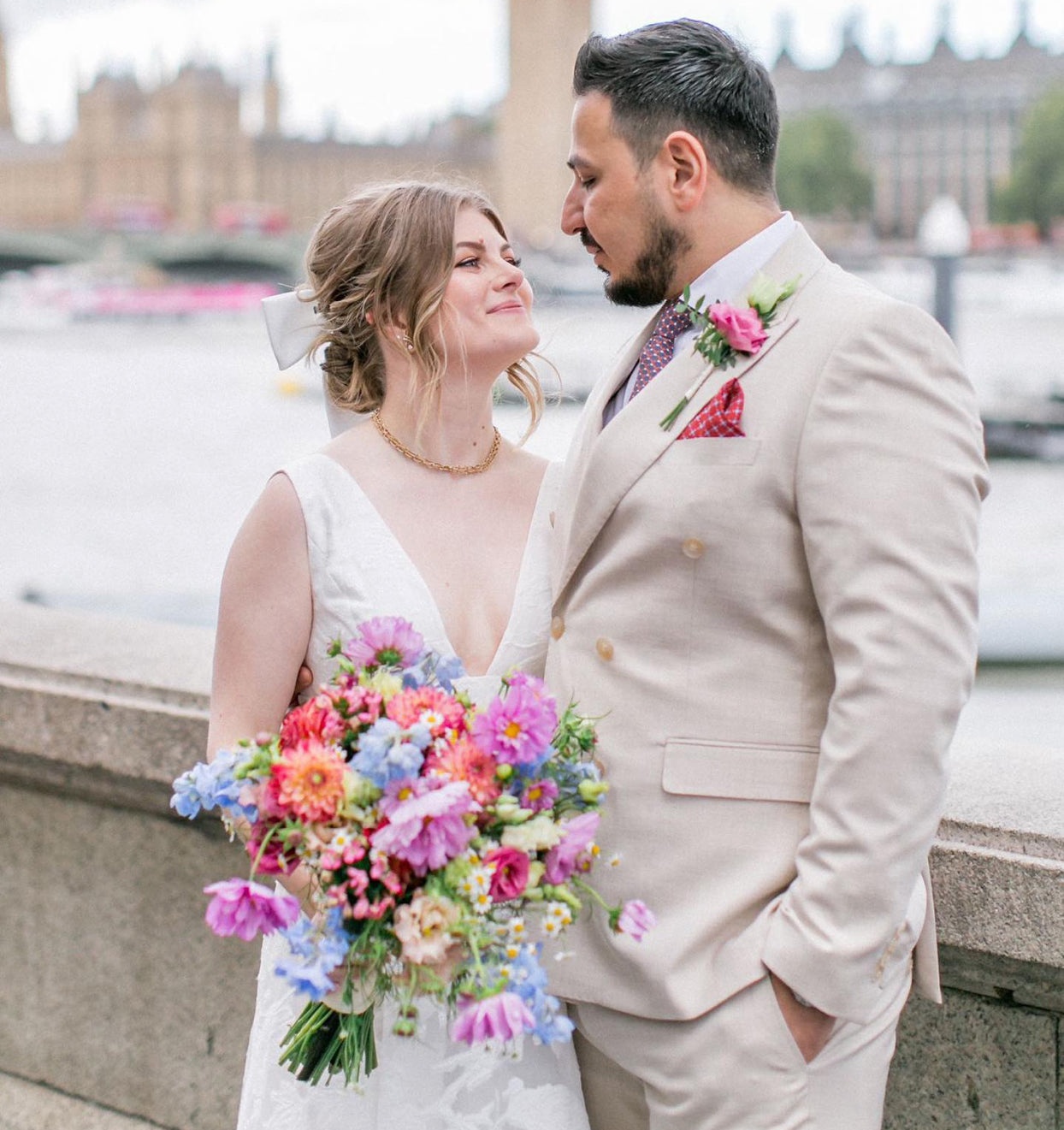 Hana and Pejman, their wedding day bouquet in coral and blue, beside the Thames, Flower Station
