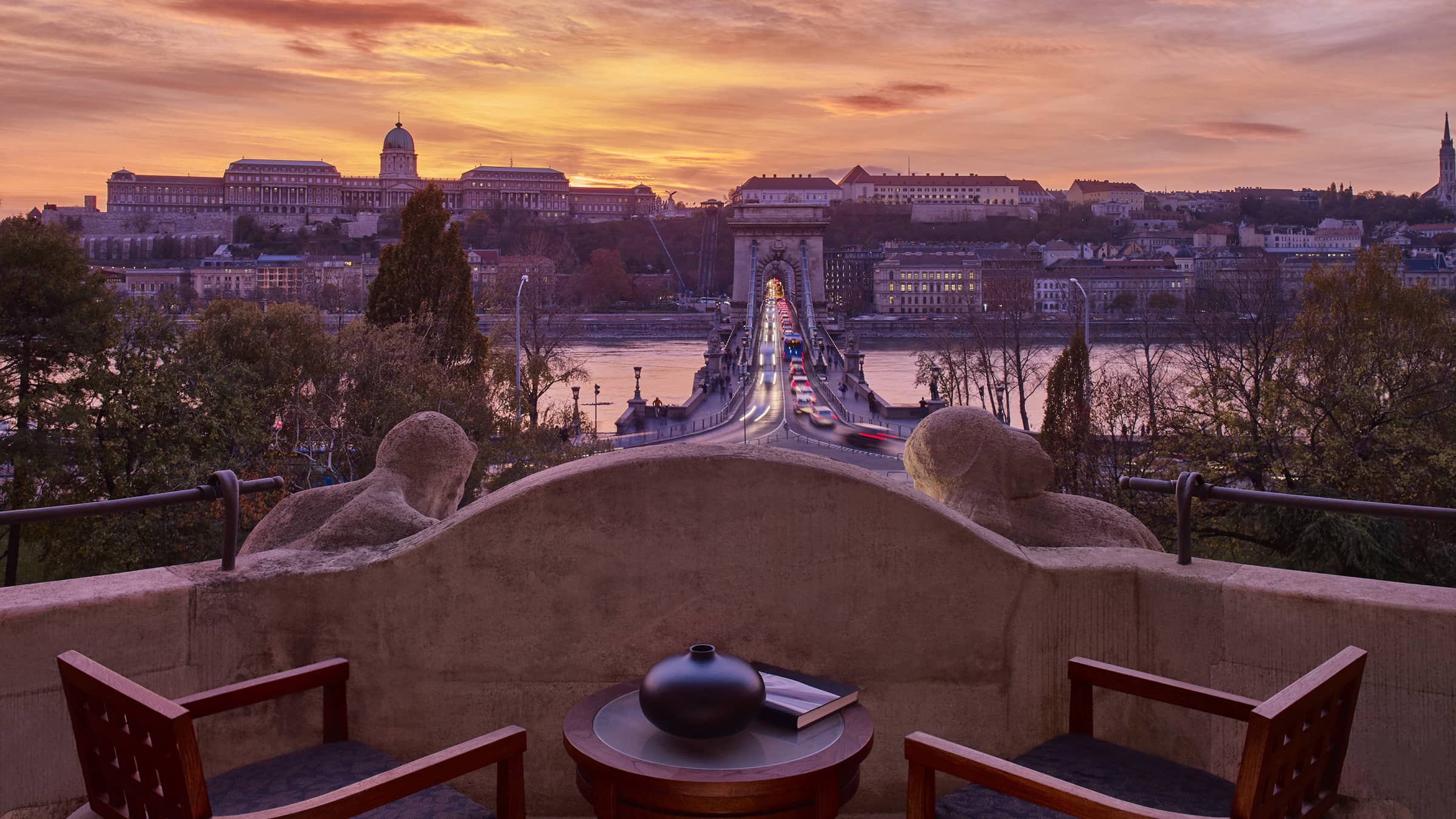 Balcony with chairs and a table above the Chain Bridge at sunset, Four Seasons Hotel Gresham Palace