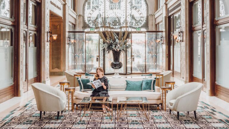 Lobby with arched glass ceiling, mosaic floor and seating, Four Seasons Hotel Gresham Palace
