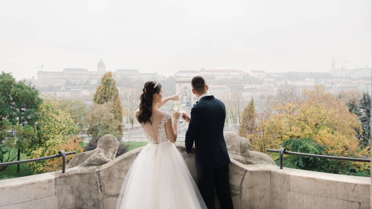 Bride and groom looking over the city from a terrace, Four Seasons Hotel Gresham Palace
