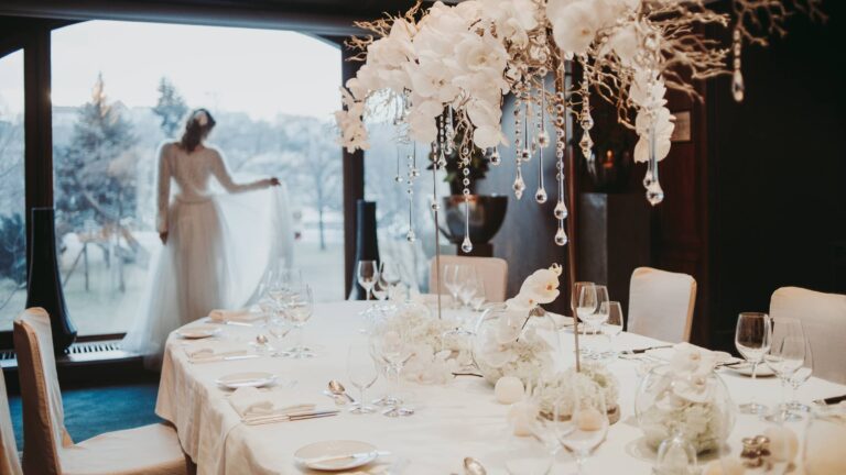 Table set with white orchids and glass icicles, bride at the window, Four Seasons Hotel Gresham Palace