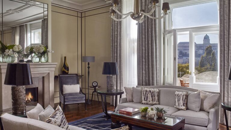 Royal Suite seating area with sofas and a fireplace, Four Seasons Hotel Gresham Palace