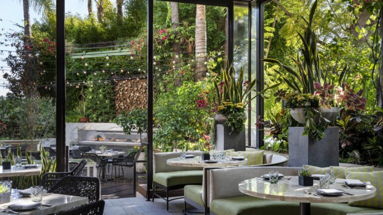 Garden terrace dining area with tropical planting, Four Seasons Los Angeles at Beverly Hills