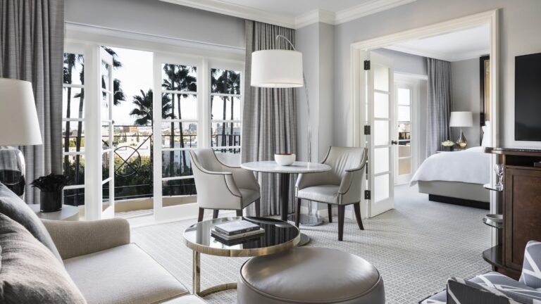 Guest room with a tufted headboard and French doors, Four Seasons Los Angeles at Beverly Hills