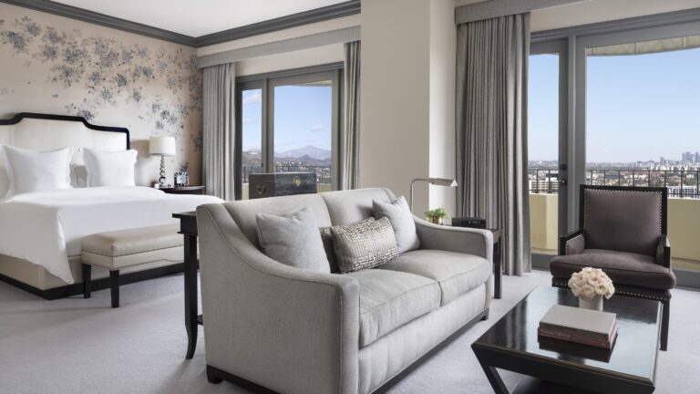 Bedroom and sitting area with a city view, Four Seasons Los Angeles at Beverly Hills
