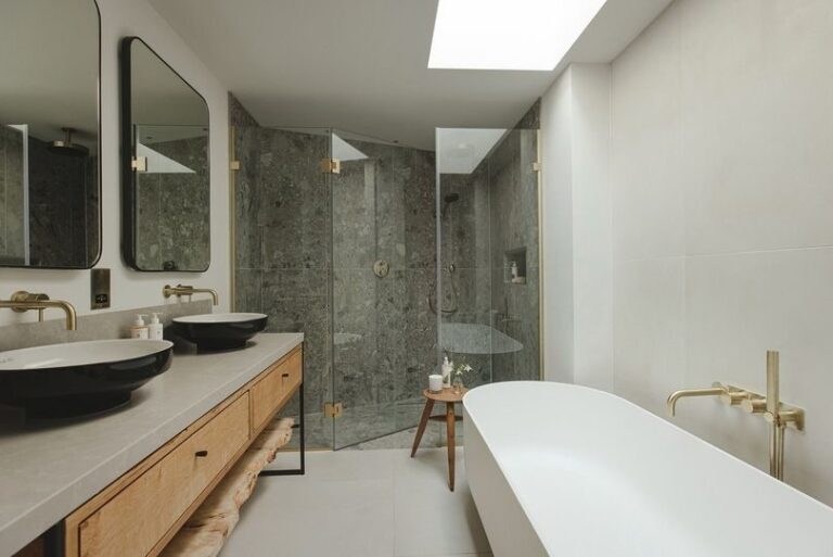 A bathroom with a freestanding tub, walk-in shower and twin vanity, Fowey Hall