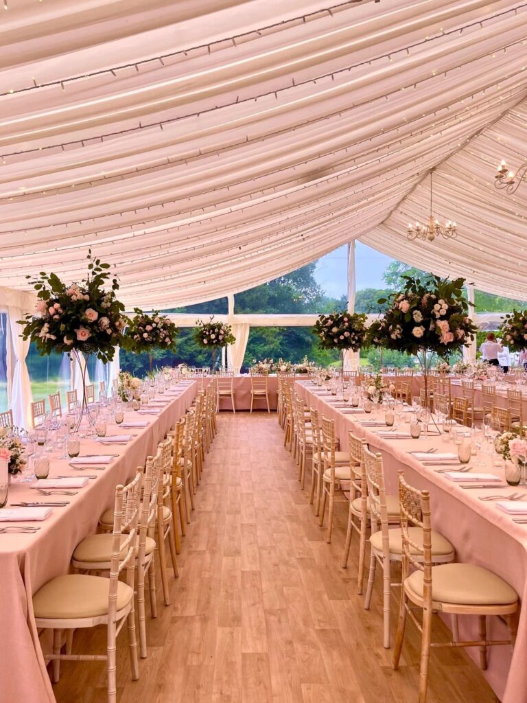 A marquee reception, tall floral pedestals down the aisle, Foxgloves and Roses